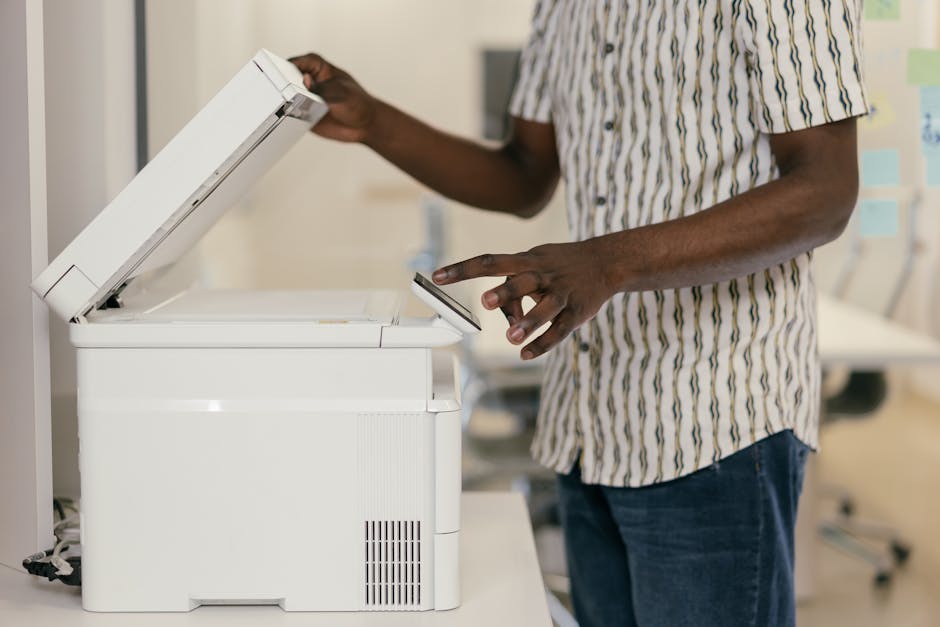 Desk with scanner, receipts, and laptop for small business capture